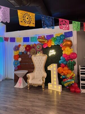 First birthday fiesta theme at The Prestige Venue with papel picado banners, colorful balloon arch, cactus balloons, and throne chair