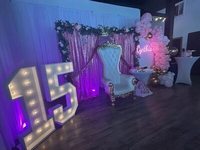 Quinceañera celebration for Cynthia at The Prestige Venue with pink and purple throne chair and 15 marquee
