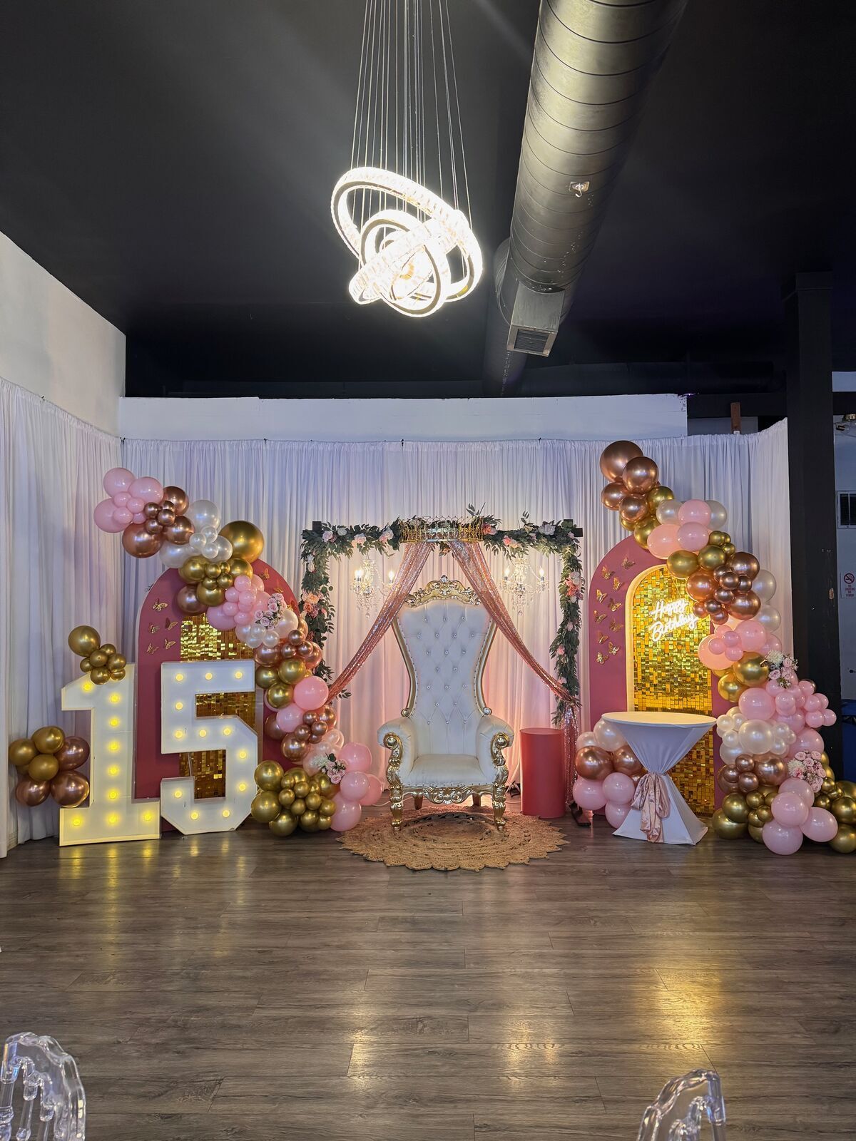 The Prestige Hall with blue uplighting, brick walls, and elegant table arrangements