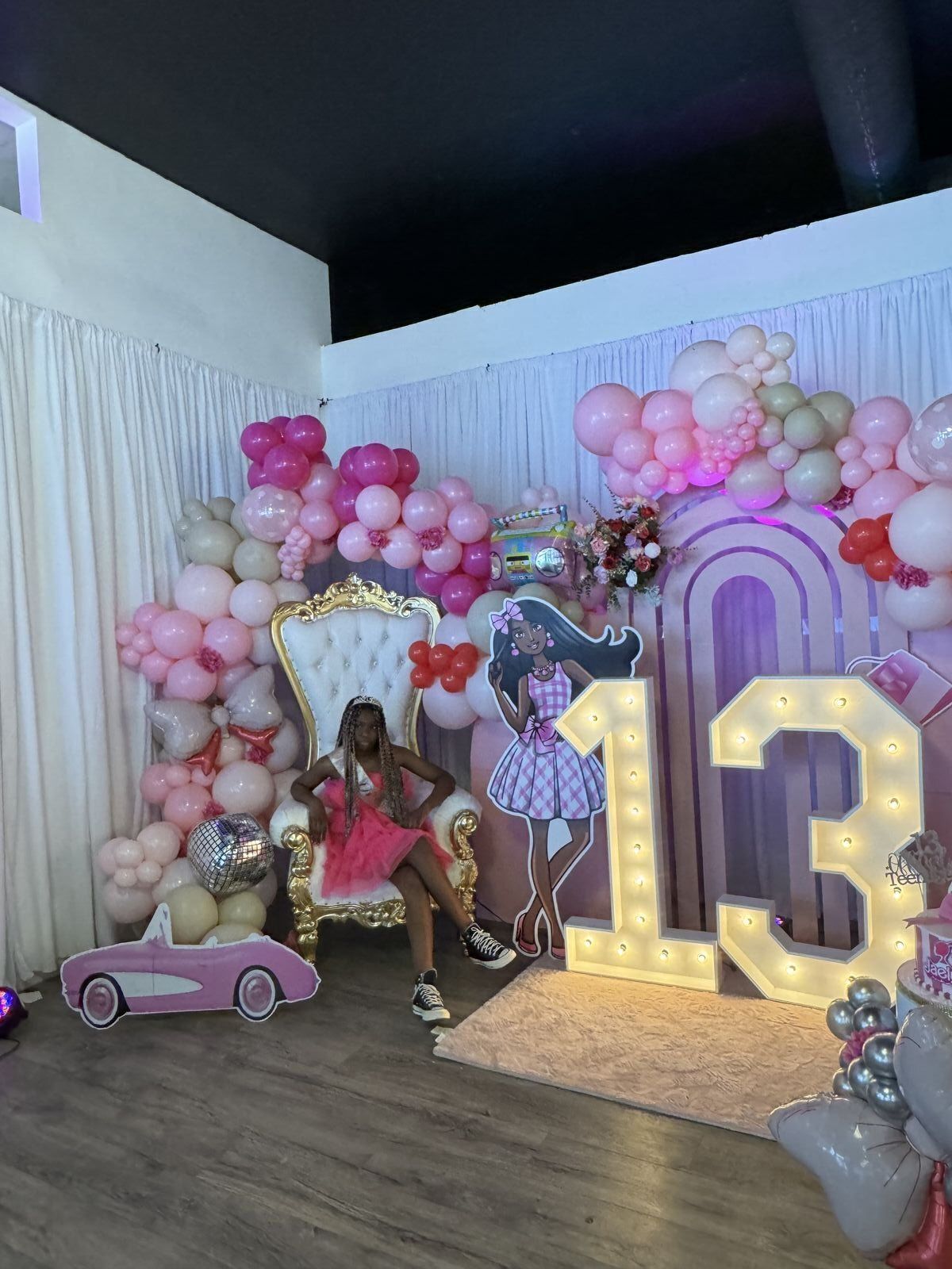 Quinceañera celebration with stunning backdrop and balloon decorations