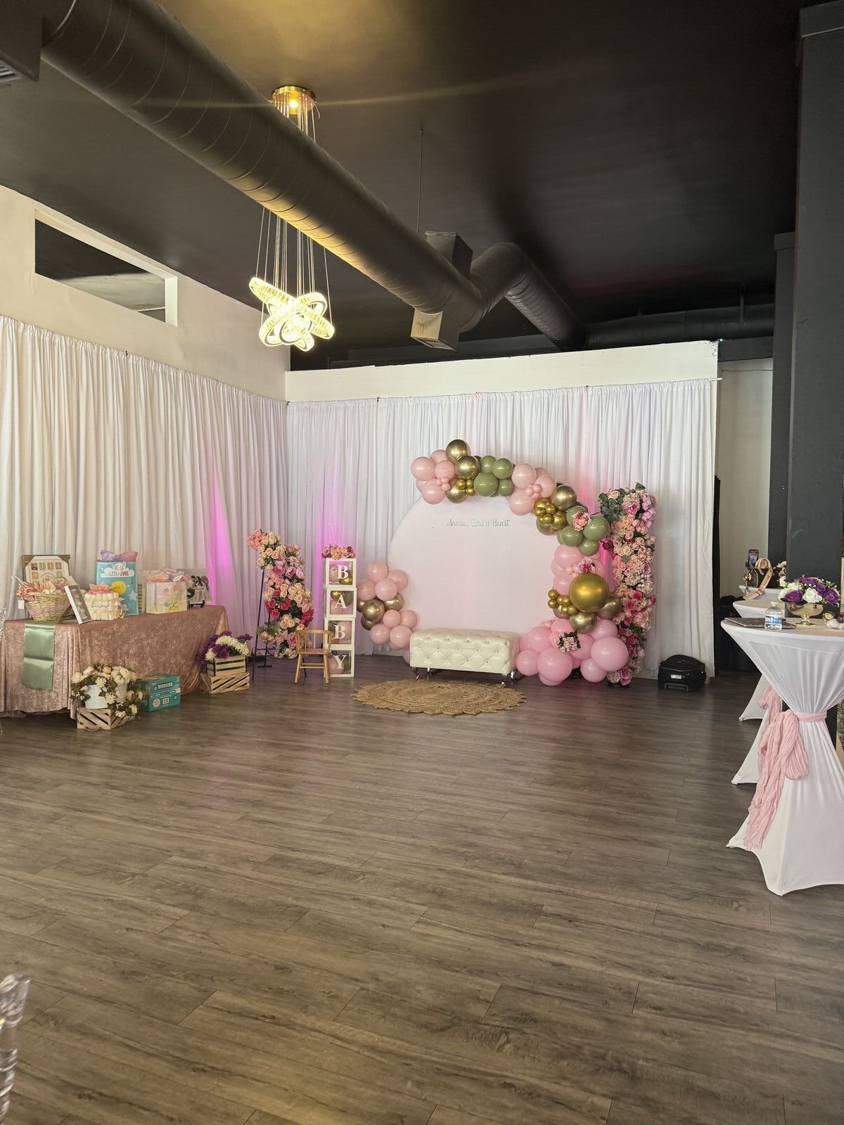 The Prestige Venue decorated for a baby shower with pink and gold accents