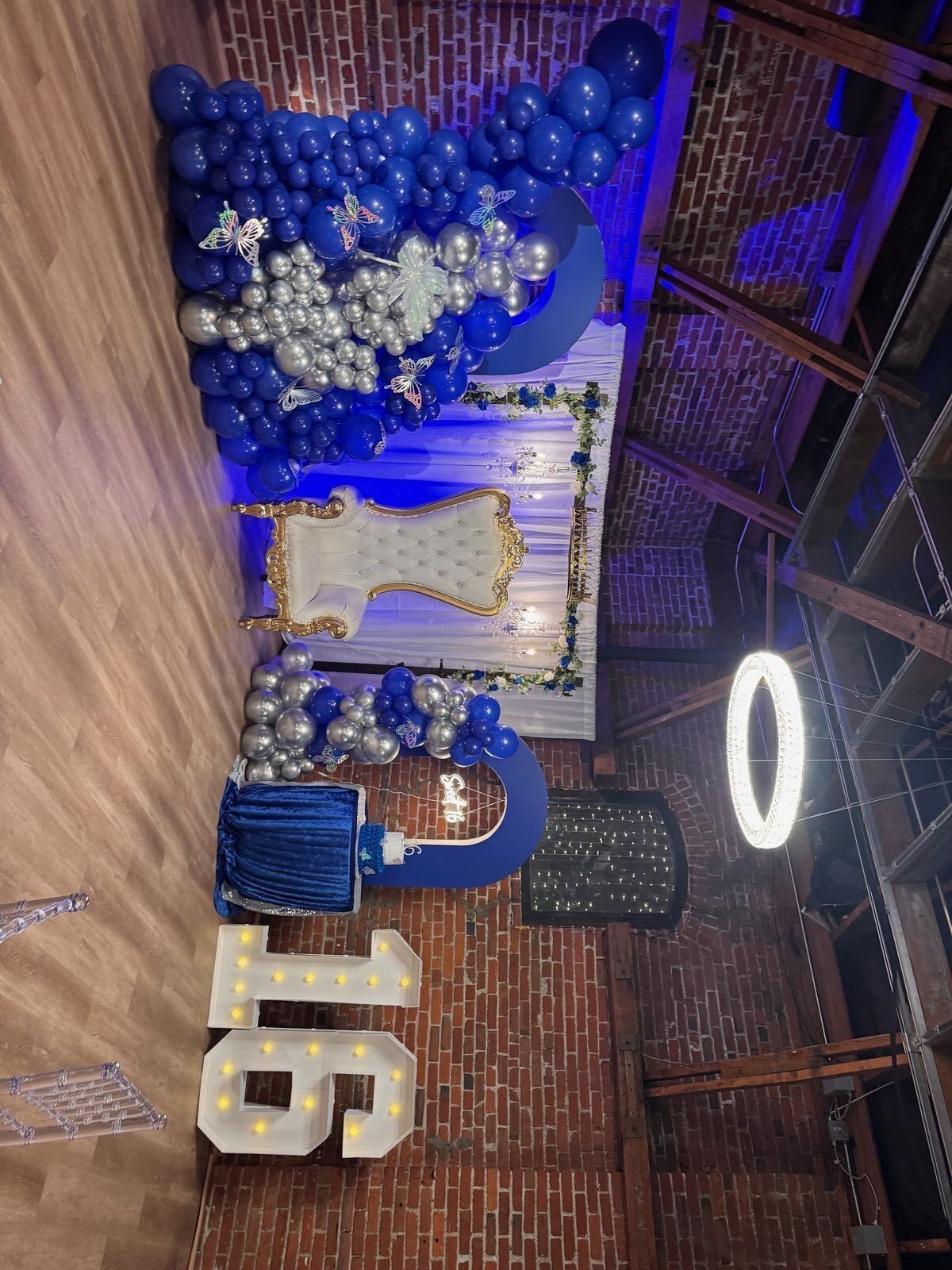 The Prestige Hall with exposed brick walls, pendant lighting, and elegant event setup